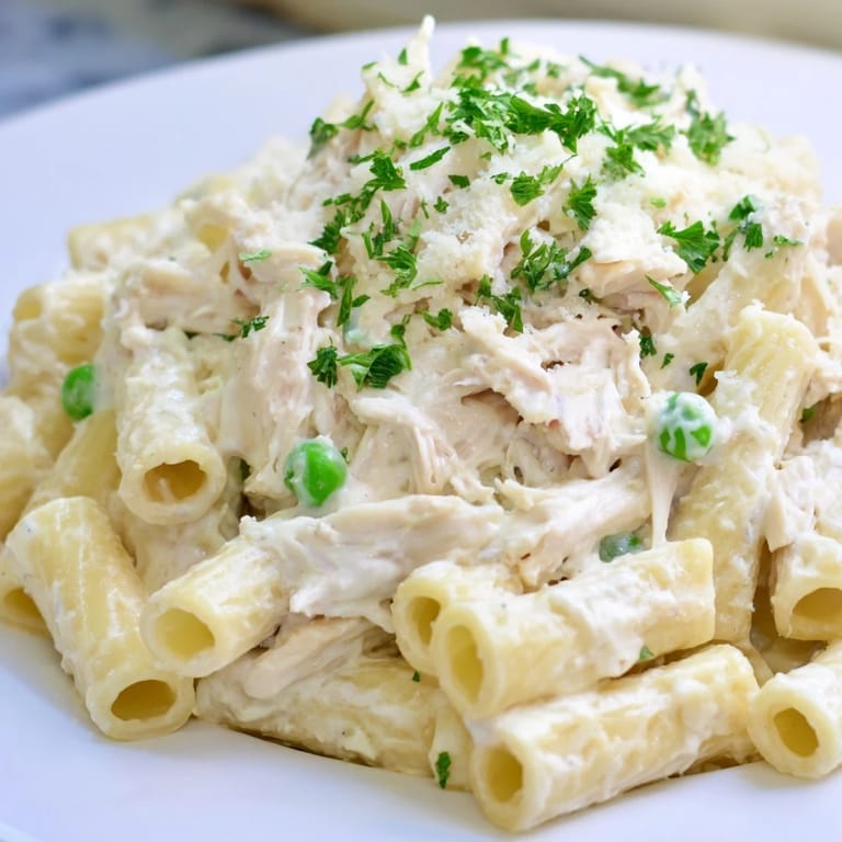 Golden, bubbly Slow Cooker Chicken Alfredo Pasta Bake, perfect for a cozy weeknight dinner; enjoy it.