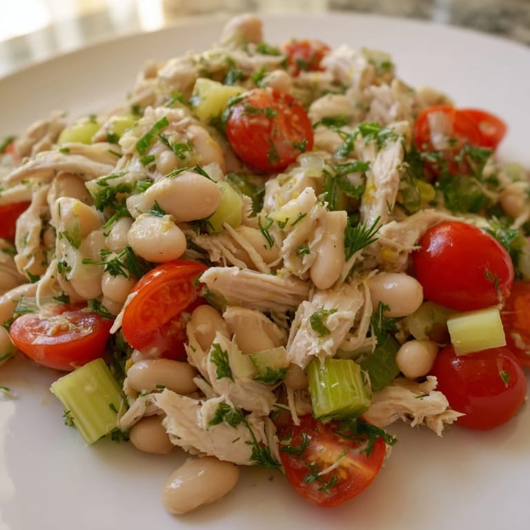 Close-up of Lemony White Bean Chicken Salad with crisp celery, cherry tomatoes, and white beans tossed in a tangy lemon dressing.