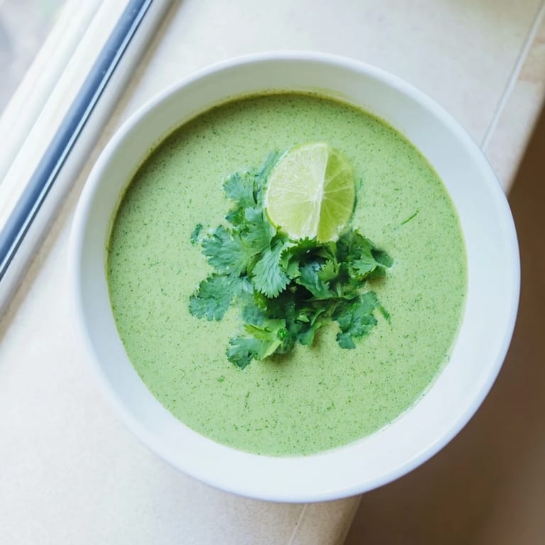 Steaming Spinach Coriander Lemongrass Soup in a rustic bowl, highlighting vibrant green hues and coconut milk.  