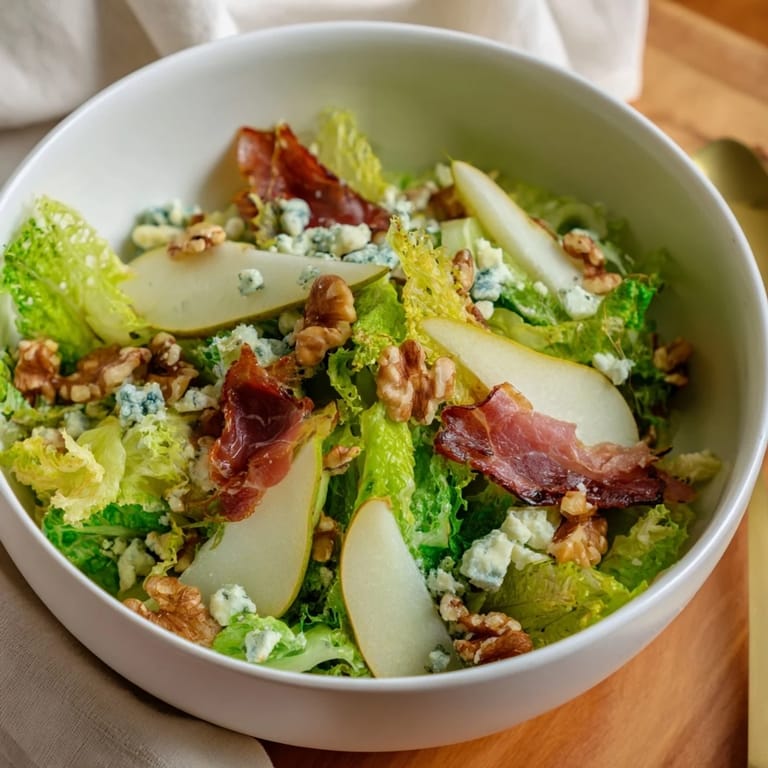 Sliced ripe pears and creamy blue cheese mingle with frisée in this elegant Frisée, Pear, Blue Cheese, and Crispy Prosciutto Salad.