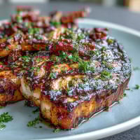 Golden seared sea scallops bathed in a bright lemon butter sauce, garnished with fresh parsley and lemon wedges.