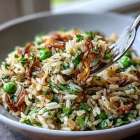 Bright Spring Pea and Mint Rice Pilaf, fluffy with vibrant peas and herbs.